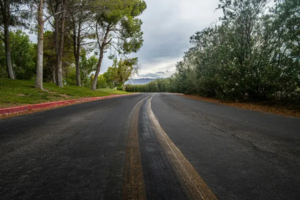 Paving machine laying a new hot asphalt layer over an existing surface