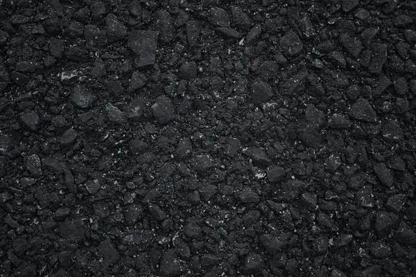 Freshly sealcoated asphalt driveway with a deep black finish